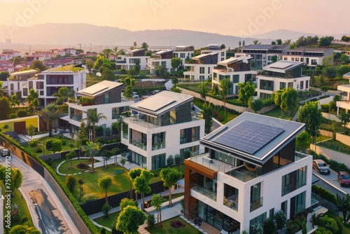 Drone view photo of urban neighborhood among private houses with solar panels on the roofs. Solar panels as eco-energy, ecology, modern architecture, mortgage, new district, urban planning, urbanism.