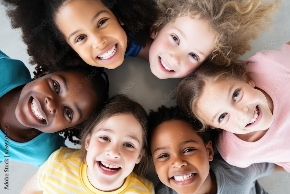 A circle of multicultural kids smiling joyfully, looking upwards, diversity in childhood. Diverse Group of Happy Children Smiling A circle of multicultural kids smiling joyfully, looking upwards, diversity in childhood. Diverse Group of Happy Children Smiling