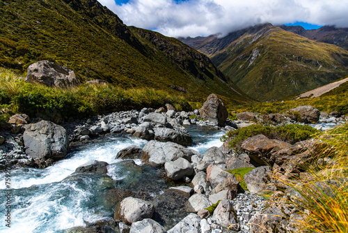 panorama of otira valley in arthur's pass national park, canterbury, new zealand south island; scenic valley with rushing river surrounded with mighty mountains photo