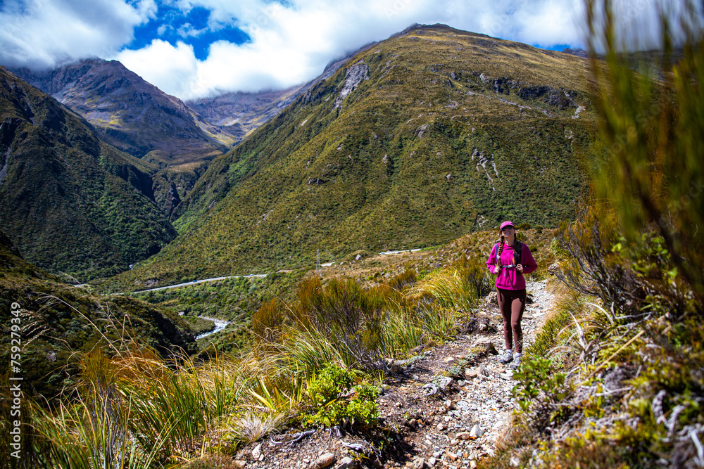 Obraz premium hiker girl enjoys a scenic path in southern alps - otira valley track in canterbury, new zealand south island, arthur's pass national park