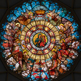 MILAN, ITALY - MARCH 5, 2024: The stained glass top of the cupola with Madonna della Salute in the church Chiesa di San Camillo by Eugenio Cisterna (1900).