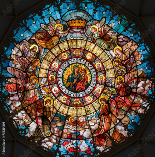 MILAN  ITALY - MARCH 5  2024  The stained glass top of the cupola with Madonna della Salute in the church Chiesa di San Camillo by Eugenio Cisterna  1900 .