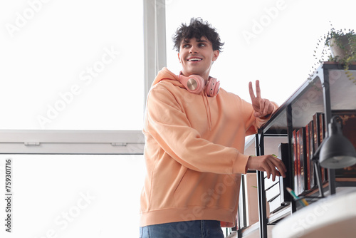 Happy young man with headph...