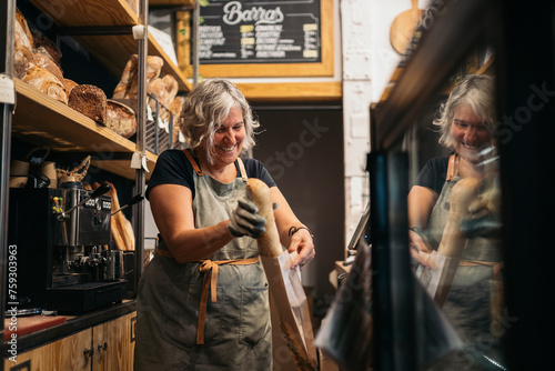 Cheerful female baker working in bakery