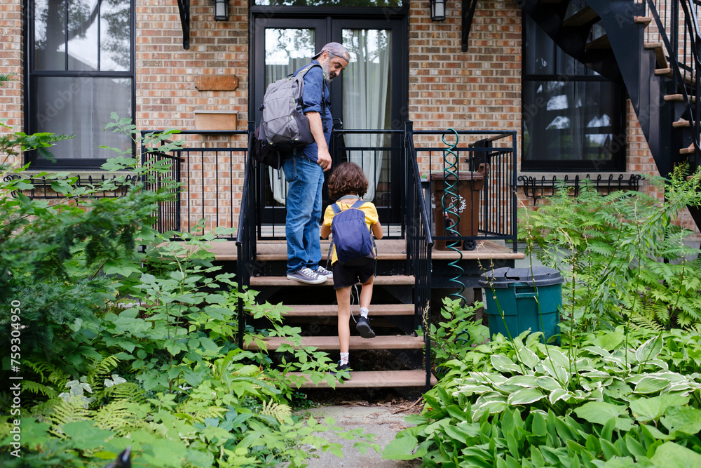 Father and daughter getting home from school