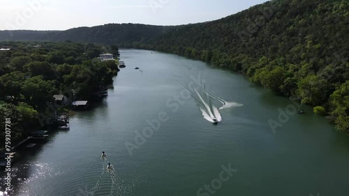 AUSTIN - 1.19.2024 - Excellent aerial footage of a person water-skiing down Lake Austin in Austin, Texas.