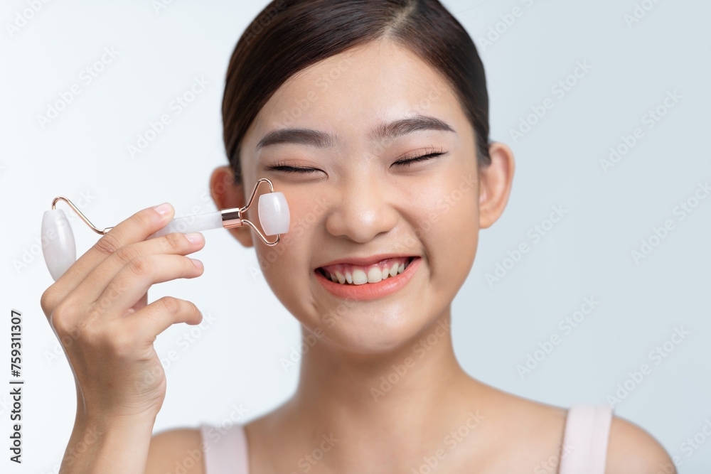 Woman doing massage with stone facial roller on white background. Woman doing massage with stone facial roller on white background.