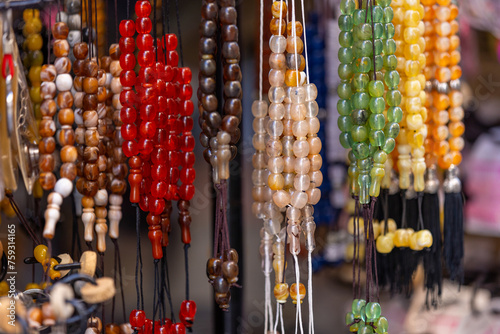 Colorful prayer beads hanging in the stall for sale photo