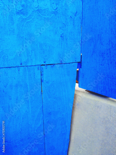 Corner of blue painted wood wall and concrete block photo