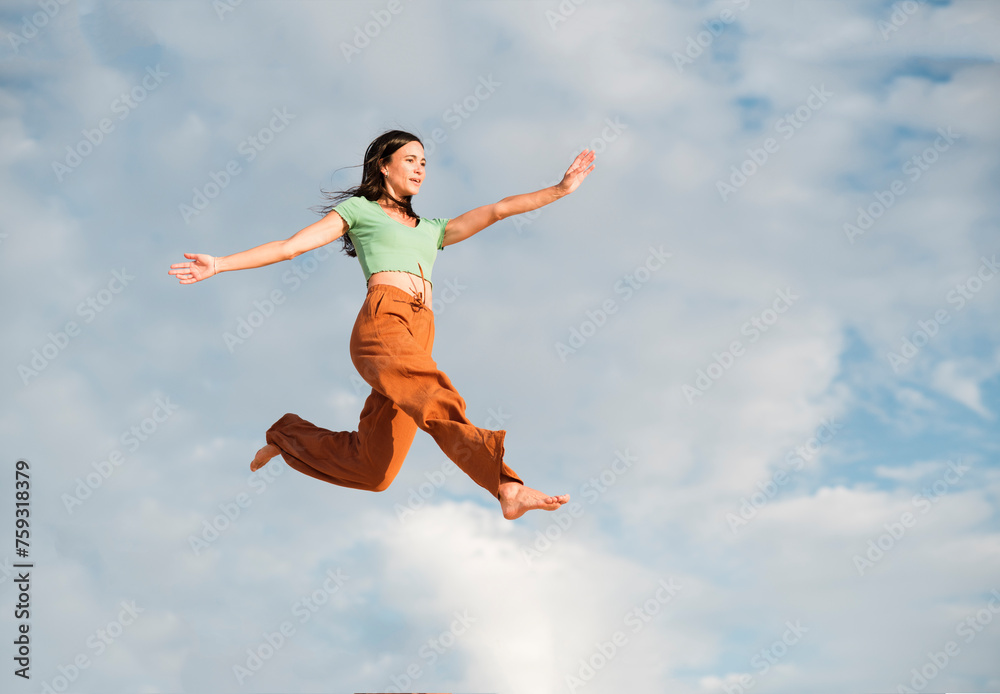 Surreal portrait of woman jumping high on the air Surreal portrait of woman jumping high on the air