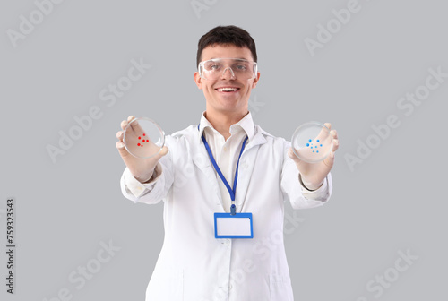Male chemist with Petri dis...