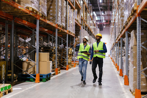 Two workers walking at storage center photo