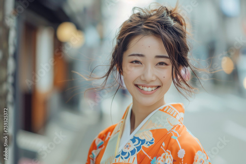 A woman wearing a kimono smiles for the camera