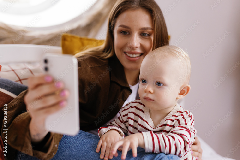 Modern motherhood toddler smartphone selfie digital era smile remotely Modern motherhood toddler smartphone selfie digital era smile remotely