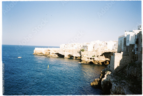 Touristic sea side town with medial city constructed over cliff rocks  photo