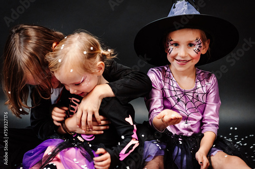 Sisters and brother having fun for Halloween photo