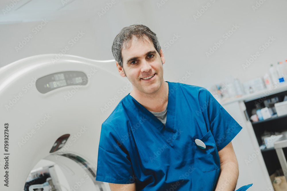 Happy adult veterinarian in uniform sitting on scanner Happy adult veterinarian in uniform sitting on scanner