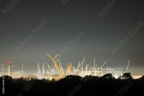 Nuclear power station being built at night.  photo