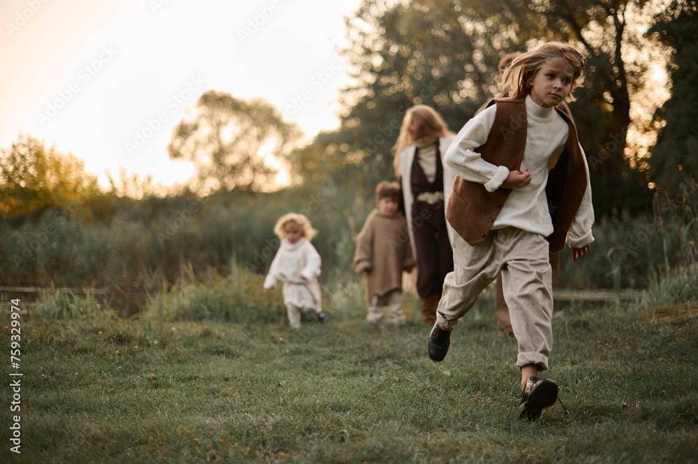 young mother playing with her little children in nature young mother playing with her little children in nature