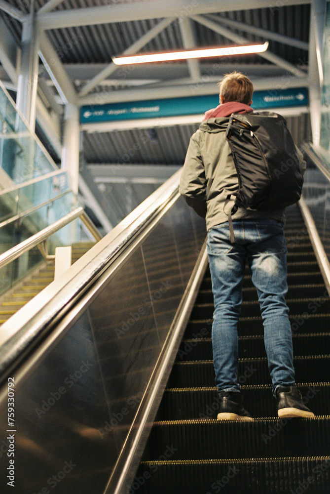 Man on escalator with backpack. Man on escalator with backpack.
