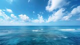 A serene and expansive view of the blue sea stretching out to the horizon, where the azure waters meet the clear blue sky in a seamless union of color and light