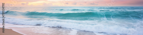 Calm and paradisiacal Caribbean beach during sunset. Sunny sea shore with foamy water and waves. Beautiful and serene beach in soft pastel pink and turquoise tones.  Summertime and marine banner.