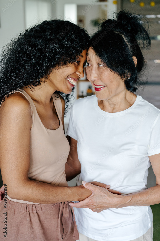 Mother and daughter hugging and looking to each other