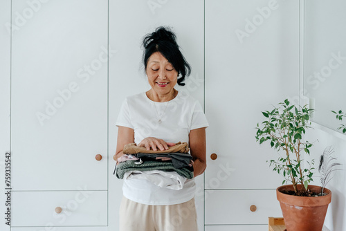 Senior woman standing near closet