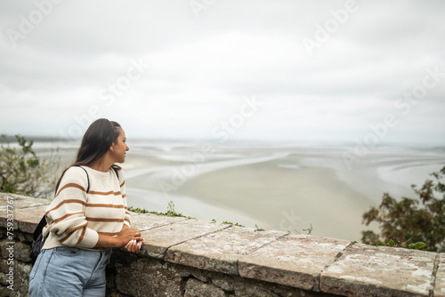 woman contemplating a seascape at Mont Saint Michel in France photo