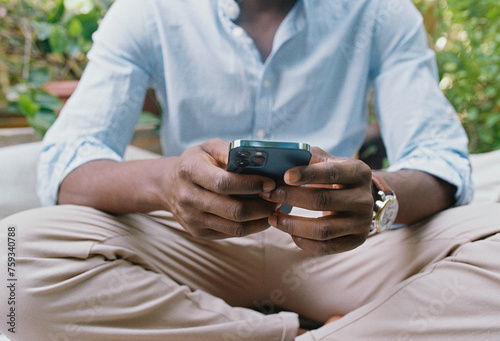 A man with a mobile phone outdoors in the garden photo