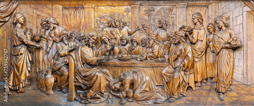 MILAN, ITALY - MARCH 5, 2024: The carved relief of The supper of Jesus by Simon the Pharisee in the church Chiesa di San Camillo by Annibale Pagnoni (1900).