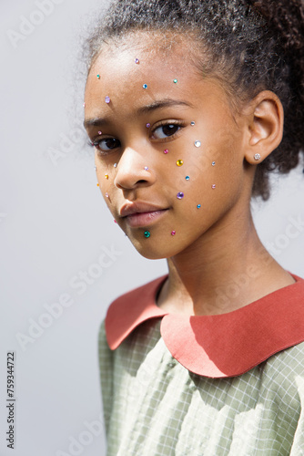 Beautiful girl with a rhinestones on face  photo