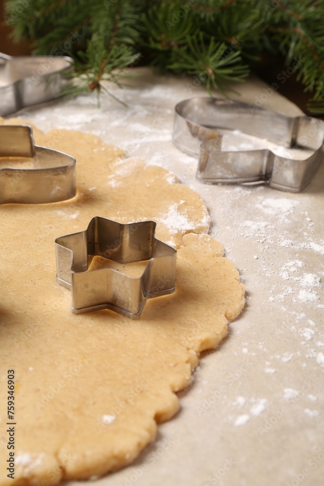Making Christmas cookies. Raw dough and metal cutters on table, closeup Making Christmas cookies. Raw dough and metal cutters on table, closeup