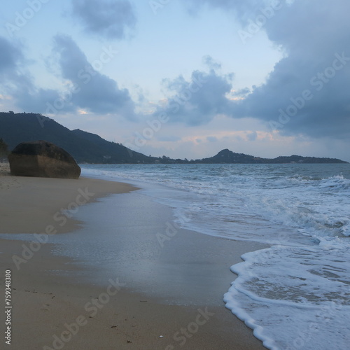 big stone in the sea on the beach in the morning