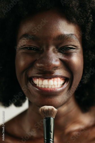 Woman using makeup brush 