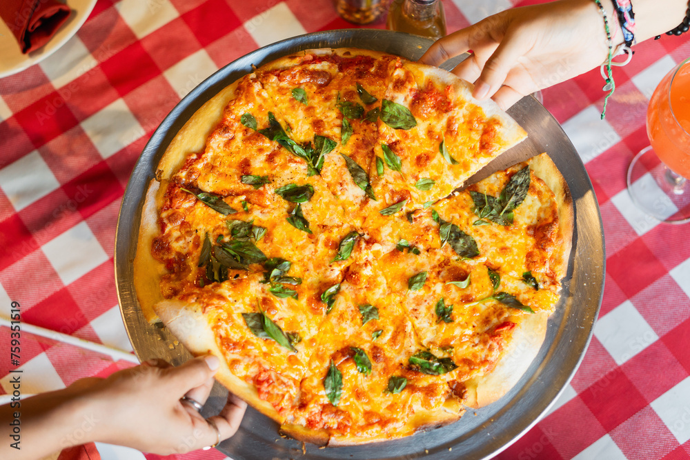 Top view of a cheese pizza on a restaurant table. Top view of a cheese pizza on a restaurant table.