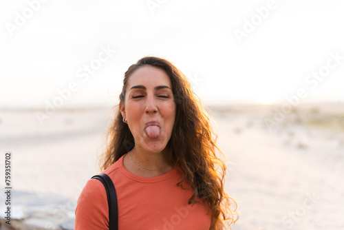 portrait of a smiling woman sticking out her tongue photo
