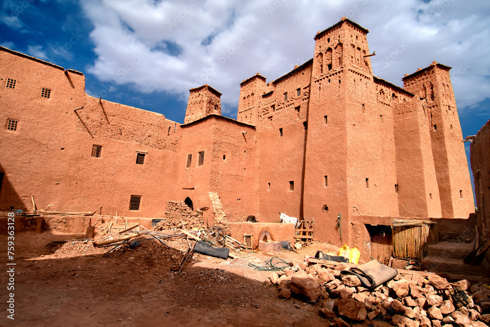 Aït Benhaddou (Arabic: آيت بن حدّو) is a historic ighrem or ksar (fortified village) along the former caravan route between the Sahara and Marrakesh in Morocco. Aït Benhaddou (Arabic: آيت بن حدّو) is a historic ighrem or ksar (fortified village) along the former caravan route between the Sahara and Marrakesh in Morocco.
