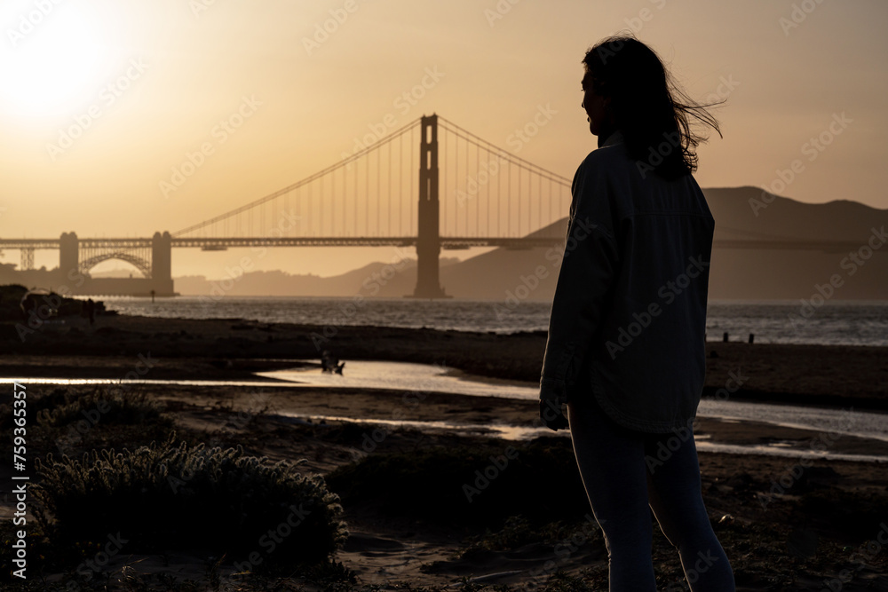 Woman in front of the Golden Gate Bridge At sunset Woman in front of the Golden Gate Bridge At sunset