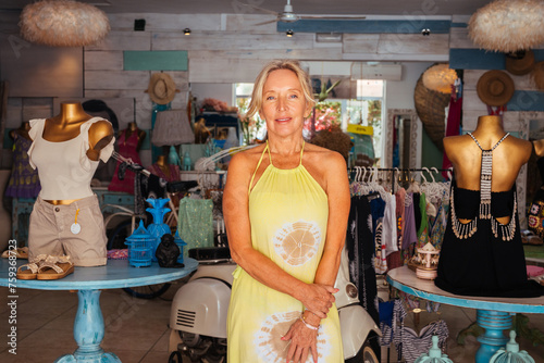 Positive female owner standing in fashion boutique photo