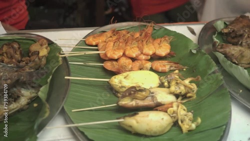 Gourami fish, gizzard liver, skewered squid, skewered shrimp, duck meat, tripe meat, tofu and chicken. Typical Indonesian food with a street food concept. Jakarta Indonesia 11 Maret 2024 photo