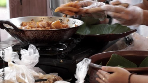 Putting krecek typical Yogyakarta food into jugs for sale, street food indonesia photo