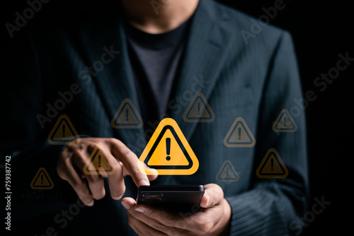 Fototapeta Naklejka Na Ścianę i Meble -  System hacked warning alert. Businessman use smartphone with warning sign for cyber attack. Ransomware, Virus, Spyware, Malware or Malicious software, Data breach, Cyber security and cybercrime.