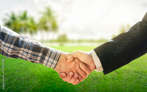 Business concept.Business handshake land purchase. Empty dry cracked swamp reclamation soil in real estate sale or property investment concept. Agriculture land plot for sales.