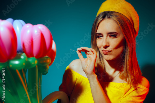 Woman Holding a Needle Ready to Pop a Balloon as Prank. Mean lady threatening to burst a party balloon
