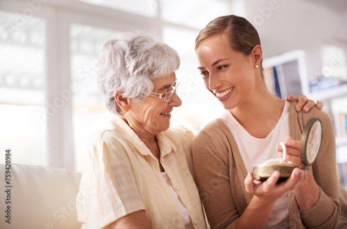 Gift box, necklace and senior mother with woman on sofa for present, giving and surprise in living room. Family, pearls and happy daughter with mom heirloom for celebration, birthday and bonding photo