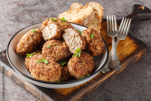 Hrechanyky or Buckwheat meatballs made of minced beef and boiled buckwheat porridge close-up in a plate on the table. Horizontal