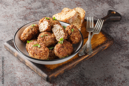 Dietary Buckwheat meatballs made of minced beef and boiled buckwheat porridge with onions, spices close-up in a plate on the table. Horizontal