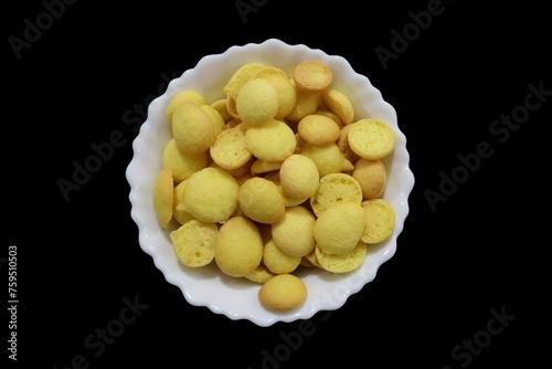 Special Orange and Yellow Crunchy Beans Cookies, commonly known as egg biscuits, are accompanied by Special Kerala Mutta biscuits, Beans biscuits, Coin biscuits, Yellow biscuits, and Baby Biscuits. photo