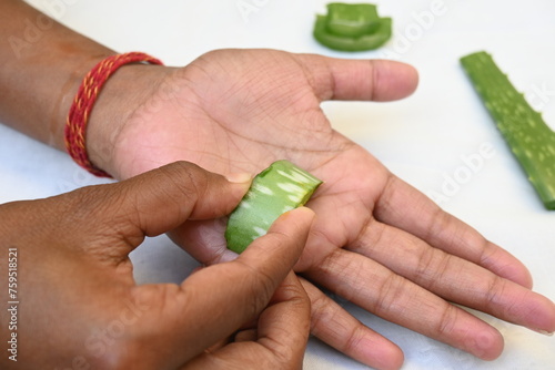 Moisturizing hands with aloe vera natural gel. Aloe Vera homemade face and body scrub recipe. Human Hand  applies aloe vera gel on a skin. Ayurvedic medicine.